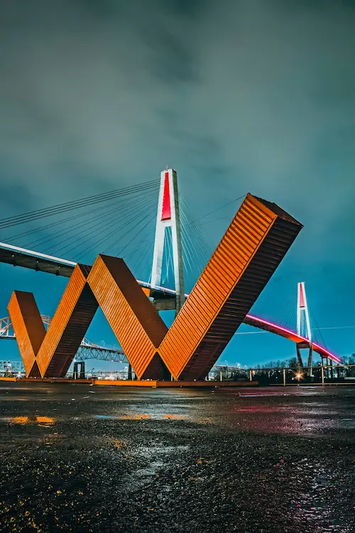 Bridge and art sculpture at night scene.