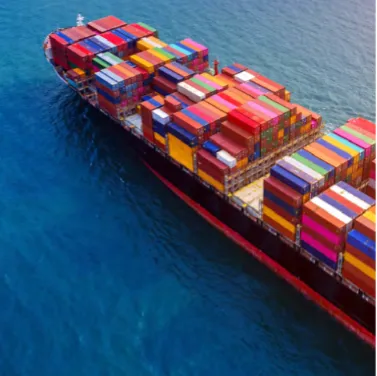 Cargo ship transporting colorful freight containers at sea.