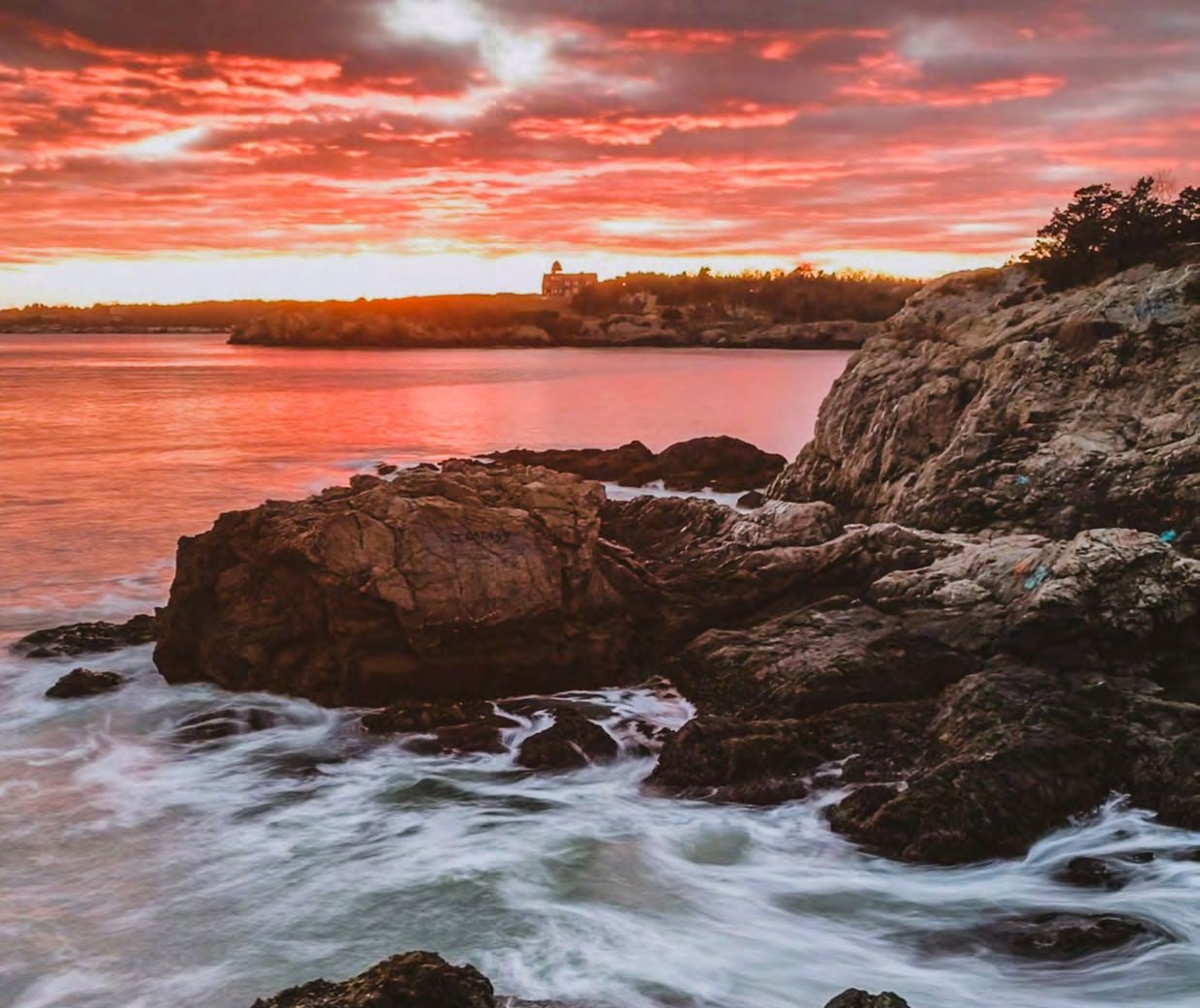 Rocky coastline at sunset with ocean waves