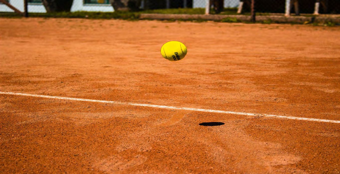 Tennis ball bouncing on clay court